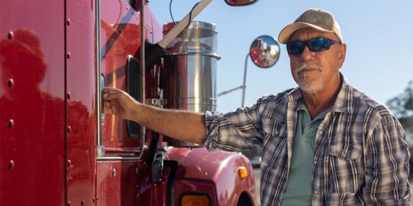 Trucker standing beside truck